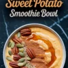 Spiced sweet potato smoothie bowl topped with pecans, pumpkin seeds, flax seeds, cinnamon, and a drizzle of maple syrup, placed on a dark marble surface with text overlay.