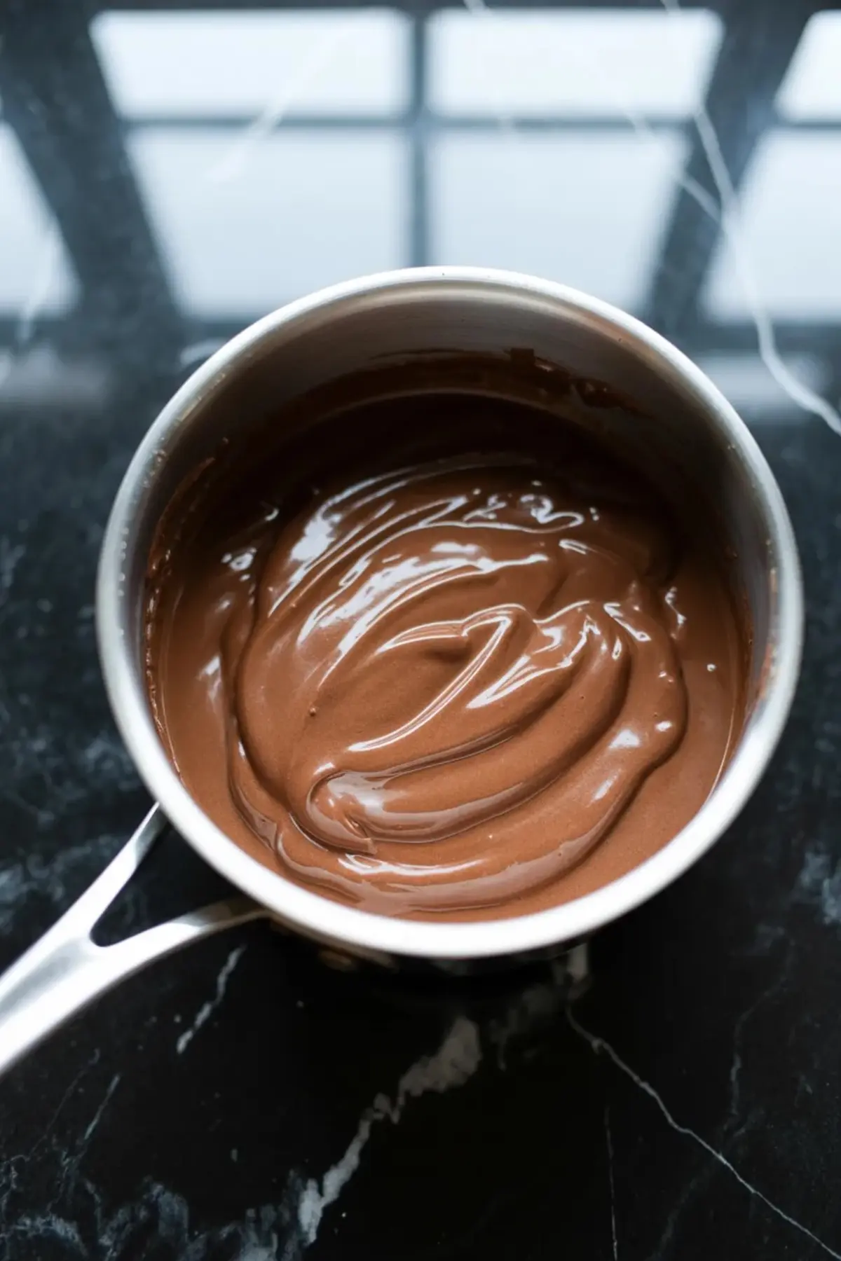 Glossy chocolate filling for chocolate cream pie bars is cooked in a saucepan until smooth and thick.